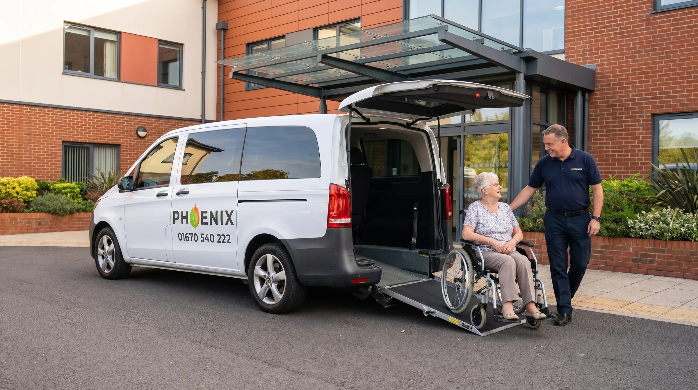 A Phoenix driver with an older passenger in a wheelchair beside a wheelchair-accessible van, ramp down, outside a hospital entrance