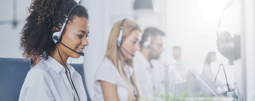 Call centre staff working in an office with headsets on